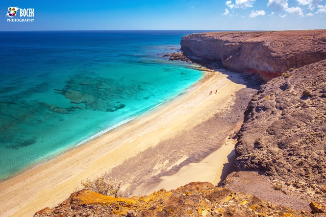 Sandy beach surrounded by cliff near Morro Jable, Jandia, Fuerte